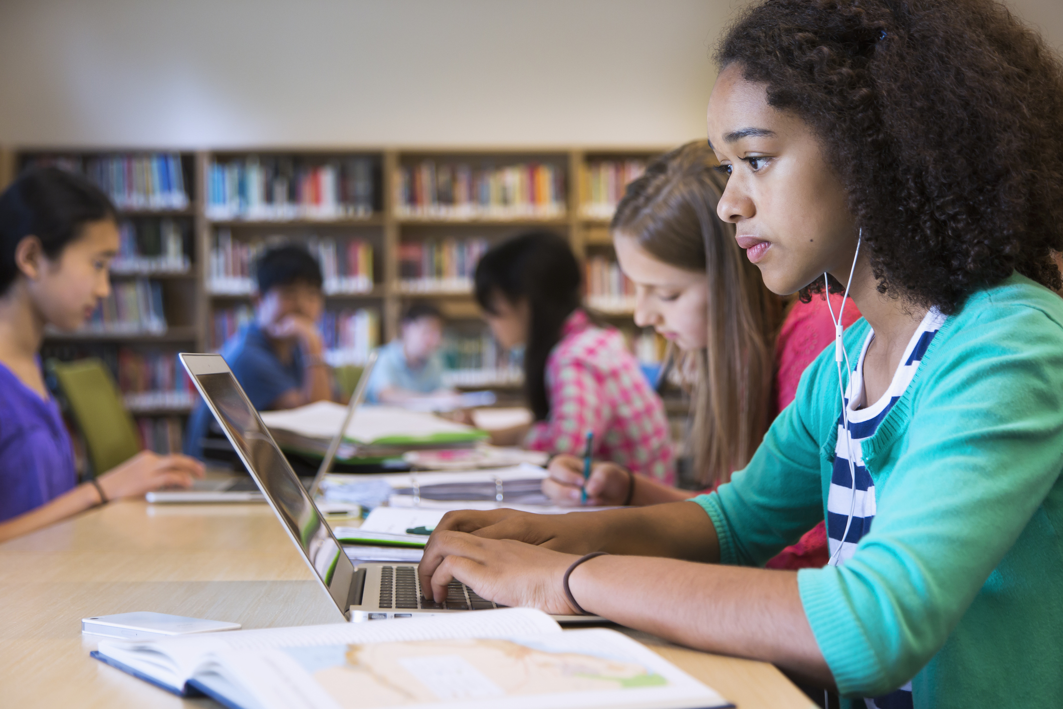 Students using laptops to work on a text-based writing activity