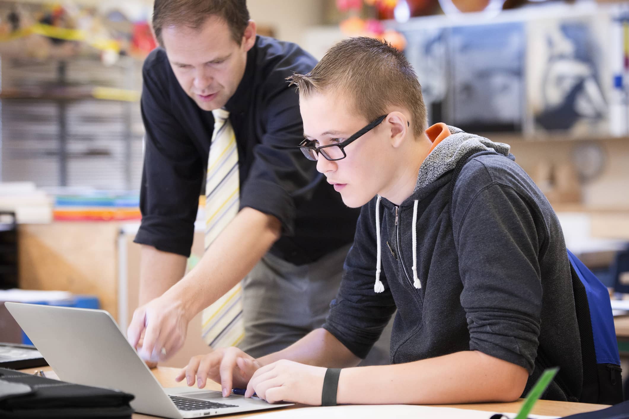 Teacher helping student using an ELA test prep website.